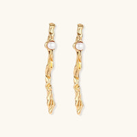 Thumbnail for Organic twisted gold-toned drop earrings with white ABS pearls positioned near the top on cream background.